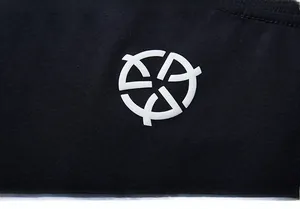Close-up of high-quality black cotton fabric texture and white geometric screen print logo