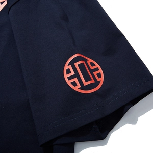 Men's loose fit dark blue cotton T-shirt featuring a red circular logo on the sleeve