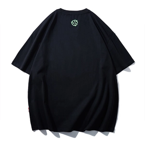 Black oversized cotton t-shirt featuring a green logo print and loose drop-shoulder design