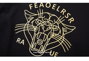 Detail of minimalist gold foil leopard head graphic on premium black sweatshirt fabric