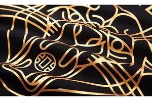 Macro detail of golden tiger print with metallic texture on black hoodie fabric