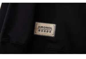 Close-up of black sweatshirt fabric featuring khaki embroidered patch with SMAKE logo text