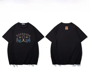 Front and back view of black oversized T-shirt with reflective lion graphic and street art