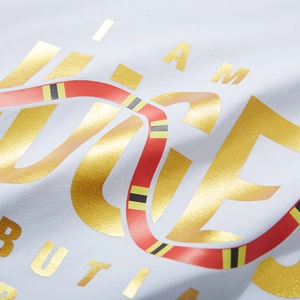 White cotton t-shirt with gold foil I AM lettering and a colorful snake graphic print