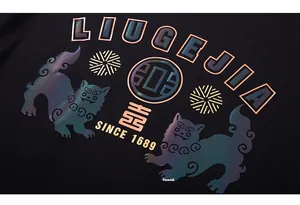 Macro shot of iridescent reflective lion print and fabric texture on a black cotton T-shirt