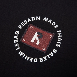 Men's oversized black sweatshirt featuring a brown leather letter R patch and logo print