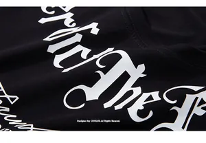 Macro view of white gothic letter printing and stitching on a black cotton oversized t-shirt
