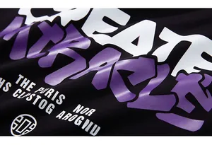 Macro view of black cotton T-shirt featuring purple and white Create Miracle graphic print