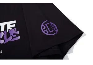 Detail of purple graphic print and stitched cuff on black cotton oversized t-shirt