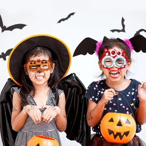 Kids Halloween party set featuring pumpkin glasses, bat wings, and orange lantern props