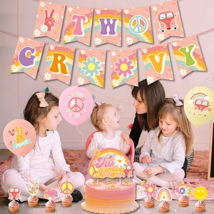Two Groovy birthday party decorations with banners balloons and hippie daisy cake toppers