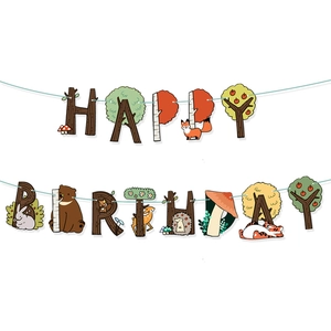 Close-up of Happy Birthday banner with forest animal patterns and wood texture