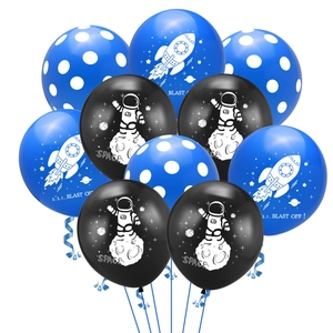 Close-up of blue and black space-themed balloons with astronaut and rocket prints