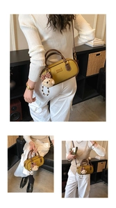 Lifestyle view showing the mustard yellow bowling bag with plush bear charm and beads