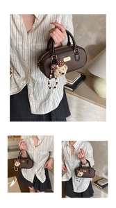 Detail of dark brown leather bowling bag with gold hardware and plush bear charm