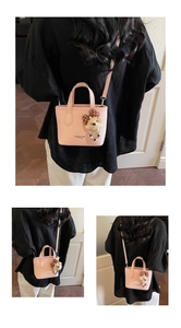 Detail view of pink textured leather bucket bag with cute plush bear charm and strap