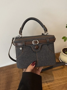 Minimalist grey denim box handbag with brown leather trim and metal buckle details