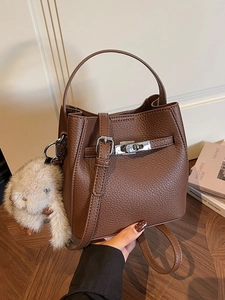 Dark brown pebbled leather bucket bag with silver twist lock and plush rabbit charm