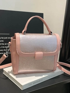 Chic silver textured square handbag with pink leather trim and adjustable crossbody strap