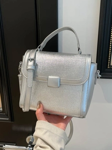 Silver square handbag with brushed metallic texture and adjustable shoulder strap