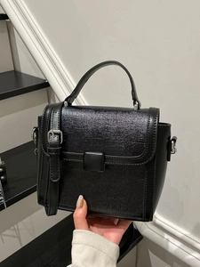 Elegant black faux leather crossbody bag with top handle and textured finish for women
