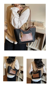 Detail of retro tote bag with black lychee texture and contrast brown pocket