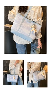 Detail of light blue printed tote bag with leather straps and horse charm for commuting