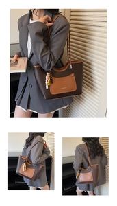 Close-up of contrast brown leather tote with litchi texture and bead charm