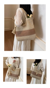 Detail of woven straw tote bag with beige brown stripes and tassel bead charm