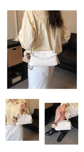 Detail of white PU leather crossbody bag featuring a cute plush bear charm with polka dot bow