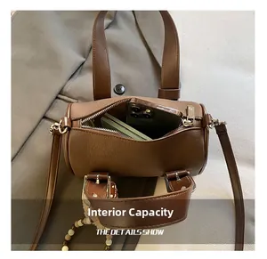 Internal capacity of retro brown leather bowling bag with phone and notebook