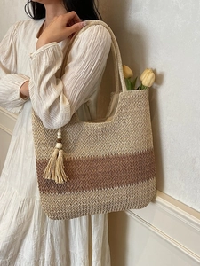 Handwoven straw tote bag with color-block design and tassels for casual shoulder carry