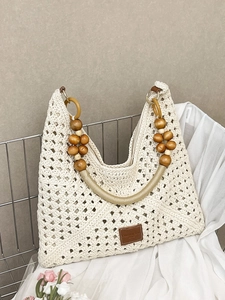 Beige hollow-out crochet tote bag with wooden bead handle for summer beach holidays