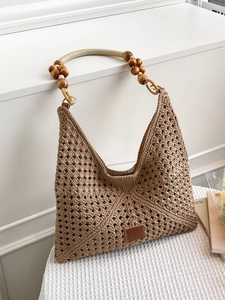 Hollow woven tote bag with wooden beads and leather patch for beach and vacation
