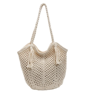 Handmade woven cotton rope tote bag with tassels and mesh hollow texture on white background