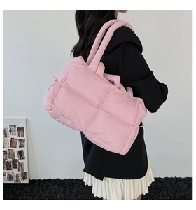 Detailed view of pink quilted puffer tote bag made of soft lightweight nylon material