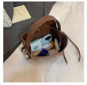 Top-down view of the brown leather bucket bag interior showing spacious storage for essentials