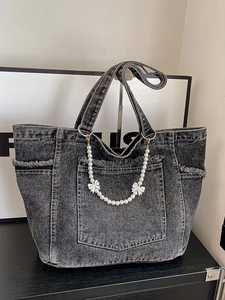Acid wash grey denim tote bag with decorative pearl bow chain and large front pocket