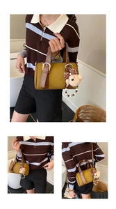 Detail of retro bowling bag in green and brown with a cute plush bear charm