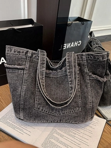 Frayed edge black denim tote bag with side pockets and double shoulder straps for casual use