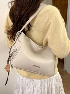 Minimalist cream white hobo shoulder bag in faux leather with silver logo and floral charm