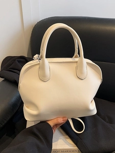 Chic off-white dome satchel bag with dual handles and matte leather texture