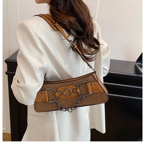 Detailed back view of a brown woven biker bag with silver chain and adjustable strap