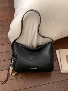 Vintage black tote bag with white contrast stitching and baseball themed keychain accessories