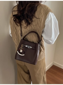Medium brown lychee pattern leather bucket bag with silver buckle and horse charm detail