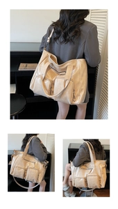 Detail of beige crocodile pattern tote bag with front pockets and adjustable strap