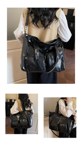 Detail of black crocodile texture tote bag with multi-pockets and silver hardware