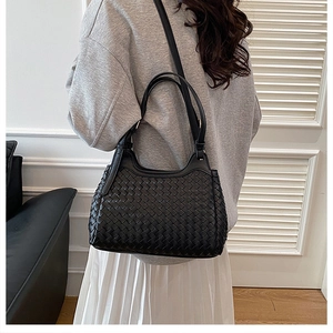 Detailed view of black woven hobo bag showing intricate Intrecciato leather texture
