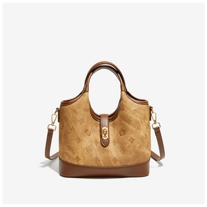 Detailed view of the tan vintage bucket bag with embossed pattern and gold metal lock