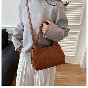 Brown woven bucket bag with intricate Intrecciato pattern and adjustable strap